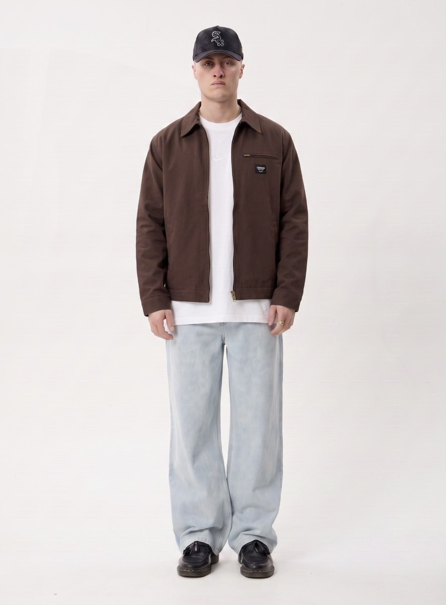 The same model, now wearing a white t-shirt and brown jacket added by Burl AI.